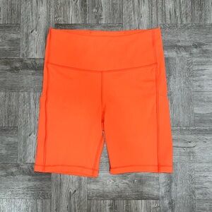 Athleta Orange Ultimate Stash Pocket 7” Bike Shorts Size Small